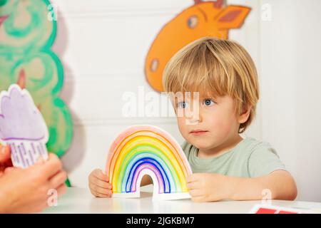 Boy in kindergarten class hold the cart with rainbow card Stock Photo