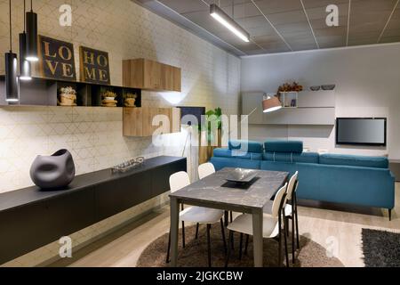 Interior of modern living room with stylish furniture and dining zone in new apartment Stock Photo