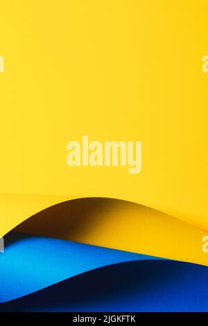 Abstract wave of yellow and light blue paper. Creative geometric curved paper with light and shadows. Abstract geometry background with copy space Stock Photo