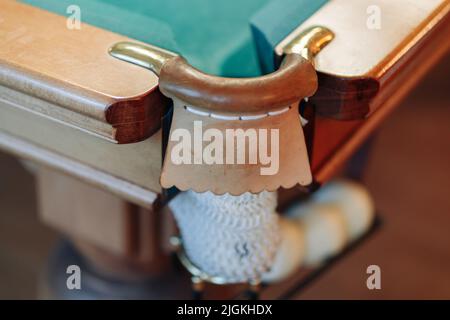 Billiard table with green surface and balls in the billiard club. Billiard pocket with white billiard balls Stock Photo