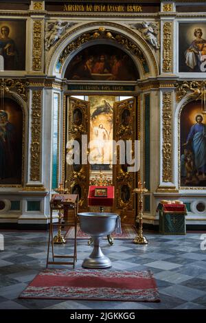 Interior and Altar in the temple Orthodox Church. Christianity. Festive interior decoration with burning candles and icon. The ceremony of infant