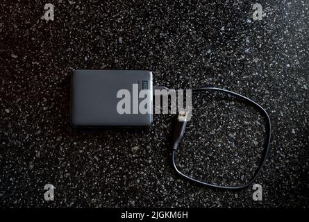External HDD WD Elements Portable in a black case with a wire on a black background. A useful portable storage device, a portable device with a high d Stock Photo