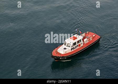 Athens, Greece - May 2022: Aerial view of a pilot boat coming alongside a ship approaching the port of Piraeus. Stock Photo