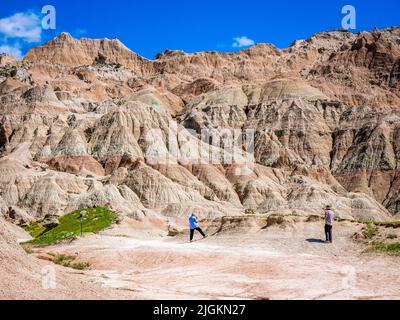 Two people photographing at Saddle Pass Trailhead area of Badlands National Park in South Dakota USA Stock Photo