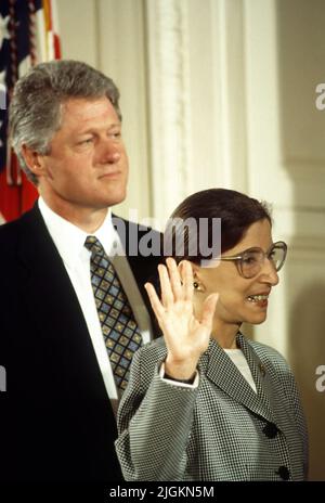 Washington DC -AUGUST 10, 1993  Ruth Bader Ginsburg is Sworn in as Associate Justice of the Supreme Court of the United States. President William Clinton stands behind her as Chief Justice  William H. Rehnquist Administers the Oath of Office. Stock Photo