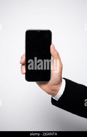 black smartphone in men's hands close-up. smartphone template for your design. Stock Photo