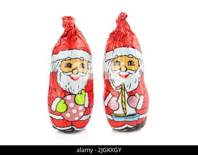 Two chocolate wrapped in foil santas isolated on white background. Holiday treats Stock Photo