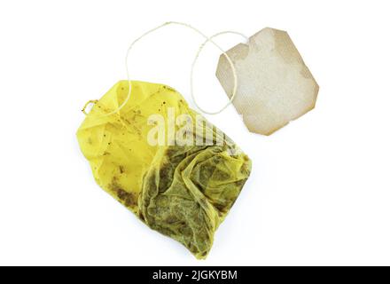 Used tea bag with blank label attached isolated on white background Stock Photo