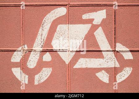 Closeup of a painted sign on the ground of a white painted bicycle on the bike lane in a city Stock Photo