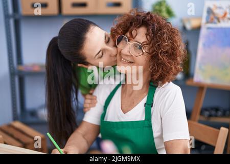 Two women artists drawing and kissing at art studio Stock Photo - Alamy