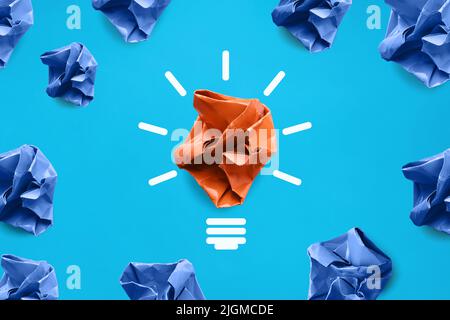 Blue colored paper balls and one orange colored crumpled paper Stock Photo