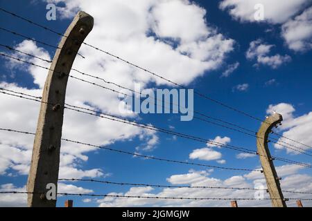 Barbed wire electric fence inside the Auschwitz II-Birkenau former Nazi Concentration Camp, Auschwitz-Birkenau, Poland. Stock Photo