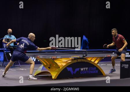 Budapest. 11th July, 2022. Daniel Habesohn (front L) returns the ball during the Men's Singles Qualifying Round 2 match between Daniel Habesohn of Austria and Niagol Stoyanov of Italy at the World Table Tennis Star Contender European Summer Series 2022 in Budapest, Hungary on July 11, 2022. Credit: Attila Volgyi/Xinhua/Alamy Live News Stock Photo