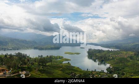 A town among tea plantations and a lake in the mountains. Maskeliya, Maussakelle reservior, Sri Lanka. Stock Photo