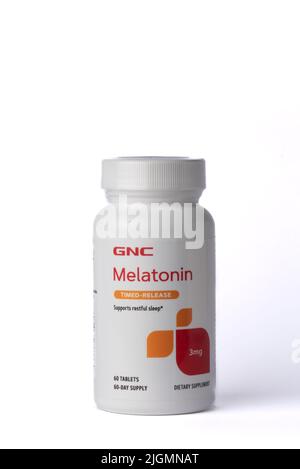 Davis, CA, July 9, 2022. Bottle of CNC Melatonin time-release 3mg against white background, centered, front view. Melatonin is a hormone used to help Stock Photo