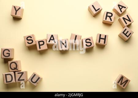 Word SPANISH made of wooden cubes on light color background, top view Stock Photo