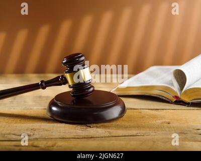 Judgment and Justice. Judge's wooden gavel and Constitution book on a beige background. Rule of law, court. Stock Photo