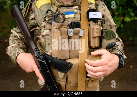 Soldier of Ukraine with assault rifle AK use smartphone. Ukrainian ...