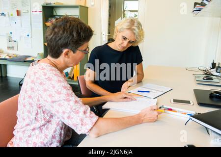 Tilburg, Netherlands. Mature adult woman having a coaching interview while searching for a new job and occupation. Stock Photo