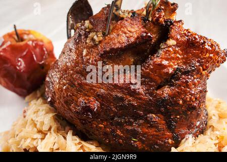 Pork leg served with stewed cabbage close-up Stock Photo