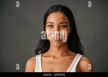 Close up dark hair African American female smiling in a studio Stock Photo
