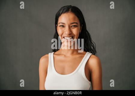 Close up young attractive multiethnic female smiling  Stock Photo