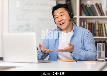 Chinese Teacher Having Class Using Laptop Making Video Call Indoor Stock Photo