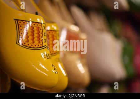 Koog aan de Zaan, Netherlands. July 2022. Colorful clogs against the background of a wooden wall. Popular souvenirs. Traditions of Holland. High quali Stock Photo