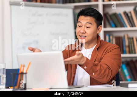 Korean Teacher Having Online Lecture Making Video Call In Classroom Stock Photo