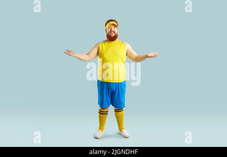 Funny happy fat man in sportswear smiling and inviting you to join fitness workout Stock Photo