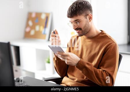 man in glasses with notebook working at office Stock Photo