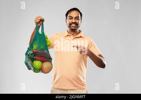 happy indian man with food in reusable net tote Stock Photo