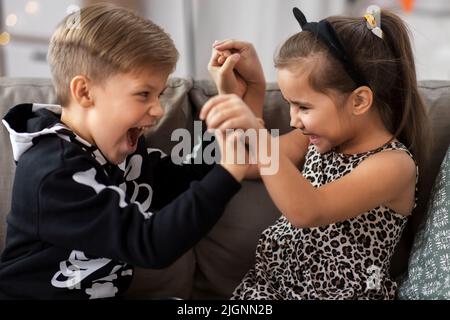 kids in halloween costumes having fun at home Stock Photo