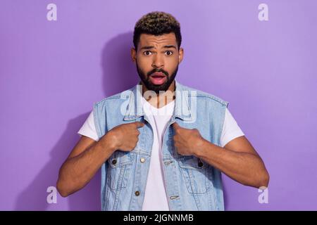 Photo of impressed offended man wear jeans waistcoat pointing fingers himself isolated violet color background Stock Photo