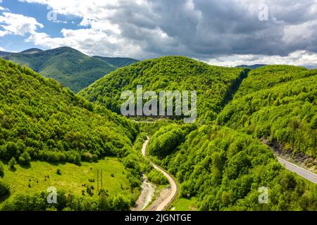 Traffic on the mountain road at the sunny day aerial view Stock Photo