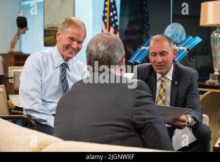 NASA Administrator Bill Nelson, left, and Associate Administrator for NASA's Science Mission Directorate, Thomas Zurbuchen, right, speak with Webb project scientist at the Space Telescope Science Institute, Klaus Pontoppidan, center, after being shown the first full-color images from NASA's James Webb Space Telescope in a preview meeting, Monday, July 11, 2022, at the Mary W. Jackson NASA Headquarters building in Washington. The first images and spectroscopic data from the world's largest and most powerful space telescope, set to be released July 11 and 12, will demonstrate Webb at its full po Stock Photo