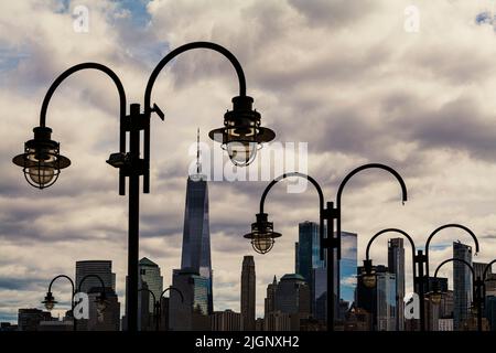 Broken street lamps on the background of the New York City and cloudy sky Stock Photo