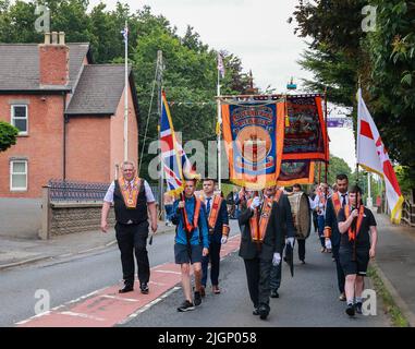 Magheralin, County Armagh, Northern Ireland.12 Jul 2022. The Twelfth of July is marked by Orange Order parades across Northern Ireland. Lodges at the Orange Hall in Magheralin, and then leaving for a short parade through the village before heading off to one of the 18 main parade venues across Northern Ireland today. This year is the first full Twelfth of July celebrations since the Covid pandemic began in 2020. The parades across Northern Ireland mark the victory of William of Orange over James at the Battle of the Boyne in 1690. Credit: CAZIMB/Alamy Live News. Stock Photo