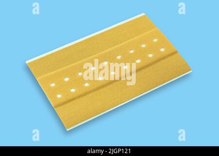 Plaster on blue background close up Stock Photo