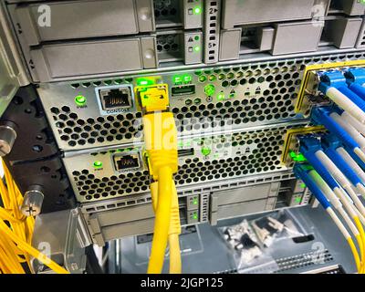 Network equipment with green lights working in a data center Stock Photo
