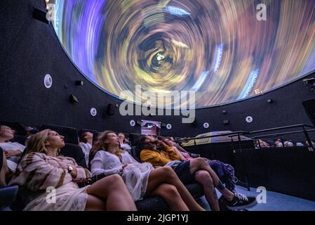 Tourists at the 'Ull del Montsec' planetarium during the projection of the video about the night, the Milky Way and astronomy (Àger, Lleida, Spain) Stock Photo