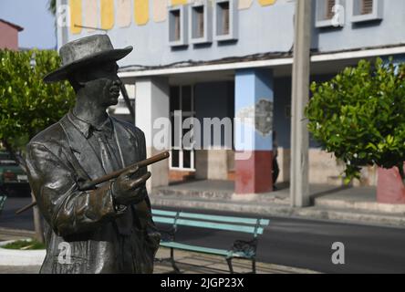 Scenic view of the bronze statue of Benny Moré the famous bandleader, singer and songwriter with his trademark cane in Prado street Cienfuegos, Cuba. Stock Photo