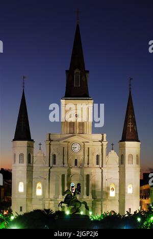 The spires of the St. Louis Cathedral borders Jackson Square, with a sculpture of Andrew Jackson on horseback and the French Quargter of New Orleans Stock Photo