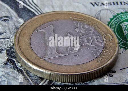 In this photo illustration, a one euro coin is seen on top of a one dollar bill. The European currency is at its lowest against the dollar. (Photo by Gerard Bottino / SOPA Images/Sipa USA) Stock Photo