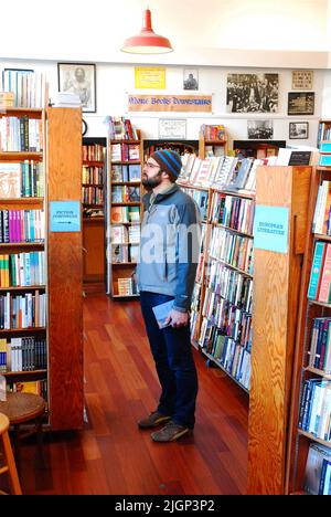 An adult man browses on the shelves of the City Lights Bookstore, in San Francisco, an independent retail operation known for progressive literature Stock Photo