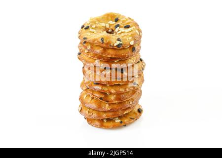 Stack of thin cracker chips with seeds isolated on white background Stock Photo