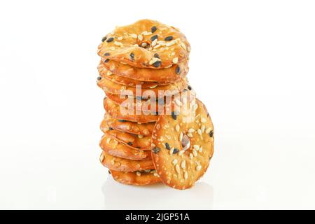 Stack of thin cracker chips with seeds isolated on white background Stock Photo