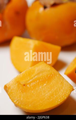 Fresh organic ripe Persimmons fruits on white  Stock Photo