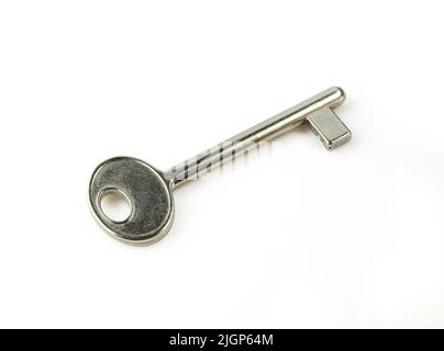 Single retro looking metallic door key isolated on white background Stock Photo