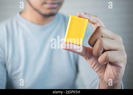 young man putting artificial sweetener in tea, Stock Photo